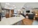 Kitchen with stainless steel appliances and a breakfast bar that opens to the living room with a stone fireplace at 2436 Covington Ave, Spring Hill, FL 34608