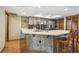 Kitchen with updated cabinets and countertops plus a breakfast bar and stainless steel appliances at 2436 Covington Ave, Spring Hill, FL 34608