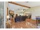 Open living space featuring wood floors, vaulted ceilings, a stone fireplace, and seamlessly connected kitchen at 2436 Covington Ave, Spring Hill, FL 34608