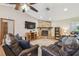 Relaxing living room featuring a stone fireplace and leather reclining sofas at 2436 Covington Ave, Spring Hill, FL 34608