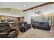 Inviting living room showcases a stone fireplace, vaulted ceilings, and access to kitchen and dining at 2436 Covington Ave, Spring Hill, FL 34608