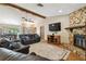 Comfortable living area featuring a stone fireplace, wood accents, and seamless access to outdoor areas at 2436 Covington Ave, Spring Hill, FL 34608
