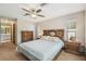 Large bedroom featuring a comfortable bed, matching nightstands, and a ceiling fan at 2436 Covington Ave, Spring Hill, FL 34608