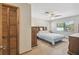 Spacious bedroom featuring a comfortable bed, matching nightstands, and a ceiling fan at 2436 Covington Ave, Spring Hill, FL 34608