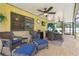 Inviting covered patio with comfortable seating, ceiling fans, and stylish outdoor decor at 2436 Covington Ave, Spring Hill, FL 34608