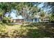 Lush backyard featuring mature shade trees, a home, and a gravel spot ready for entertainment at 2616 47Th N Ave, St Petersburg, FL 33714