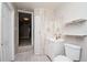 Clean bathroom with a white vanity, toilet, and shelving, offering a simple and functional space at 2616 47Th N Ave, St Petersburg, FL 33714
