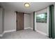 Bedroom features gray walls, a window with green curtains, and a sliding barn door at 2616 47Th N Ave, St Petersburg, FL 33714