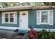 Inviting front entrance with a white door, decorative windows, and freshly planted garden at 2616 47Th N Ave, St Petersburg, FL 33714