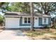 Charming single Gathering home with white trim, light blue siding and an attached garage at 2616 47Th N Ave, St Petersburg, FL 33714