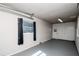 Garage features gray walls, gray floor, and a small window with black curtains at 2616 47Th N Ave, St Petersburg, FL 33714