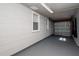 Garage features gray walls, gray floor, white trim, two windows, and a garage door at 2616 47Th N Ave, St Petersburg, FL 33714