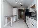 Galley kitchen features white cabinets, stainless steel appliances, and granite countertops at 2616 47Th N Ave, St Petersburg, FL 33714