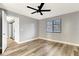 Inviting bedroom featuring wood-look floors, updated fan and ensuite bathroom access at 2696 60Th Avenue W Ter # 10, Bradenton, FL 34207