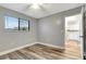 Bedroom with hardwood flooring, a ceiling fan, and a view of the kitchen at 2696 60Th Avenue W Ter # 10, Bradenton, FL 34207