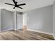 Spacious bedroom with wood-look floors, ceiling fan and doorway at 2696 60Th Avenue W Ter # 10, Bradenton, FL 34207