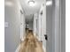 Hallway view showcases the flooring, updated bathroom and open kitchen layout at 2696 60Th Avenue W Ter # 10, Bradenton, FL 34207