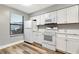 Bright kitchen featuring white cabinets, stainless steel appliances, and modern flooring at 2696 60Th Avenue W Ter # 10, Bradenton, FL 34207