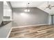 Bright living room featuring vaulted ceilings, modern flooring, and open access to the kitchen at 2696 60Th Avenue W Ter # 10, Bradenton, FL 34207