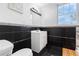 Bathroom with black tiled walls and floor, white vanity and updated fixtures at 2700 10Th W St, Palmetto, FL 34221