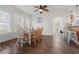 Bright dining room featuring hardwood floors, a ceiling fan, and an adjacent breakfast bar at 2700 10Th W St, Palmetto, FL 34221