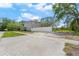 Two story home featuring grey siding and a white vinyl fence surrounding the yard at 2700 10Th W St, Palmetto, FL 34221