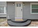 Close-up of the front door with sidelight, black steps, and stylish exterior lighting at 2700 10Th W St, Palmetto, FL 34221