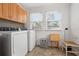 Bright laundry area with wooden cabinets and front loading washer and dryer at 2700 10Th W St, Palmetto, FL 34221