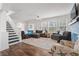 Bright living room features a modern ceiling fan, hardwood floors, and beach-themed decor at 2700 10Th W St, Palmetto, FL 34221