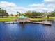 Aerial view of a lakefront park featuring a fishing pier and gazebo, offering recreational opportunities at 2712 Clubhouse Dr, Plant City, FL 33566