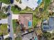Aerial view of home with pool, well-maintained lawn, and mature landscaping in a suburban neighborhood at 2712 Clubhouse Dr, Plant City, FL 33566