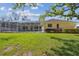 Expansive backyard with a screened-in pool and a well-kept lawn, ideal for leisure and entertainment at 2712 Clubhouse Dr, Plant City, FL 33566