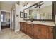 A bathroom featuring a double sink vanity, large mirror, and a bathtub with a shower at 2712 Clubhouse Dr, Plant City, FL 33566