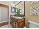 Elegant bathroom vanity with granite countertops, dual sinks, and decorative wall art at 2712 Clubhouse Dr, Plant City, FL 33566