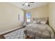 Cozy bedroom with a plush bed, patterned rug, and a comfortable reading chair at 2712 Clubhouse Dr, Plant City, FL 33566