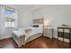 Charming bedroom with hardwood floors, a cozy bed, and natural light from the window at 2712 Clubhouse Dr, Plant City, FL 33566