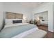 Bedroom with wood floors, natural lighting, a mirrored closet, and a full-sized bed at 2712 Clubhouse Dr, Plant City, FL 33566