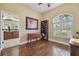 Bedroom with hardwood floors, shutters, and an arched window for plenty of natural light at 2712 Clubhouse Dr, Plant City, FL 33566