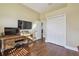 Bedroom featuring wood floors, a desk with two tvs, and a closet at 2712 Clubhouse Dr, Plant City, FL 33566