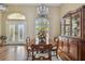 Elegant dining room with chandelier, wainscoting, and double door entryway at 2712 Clubhouse Dr, Plant City, FL 33566
