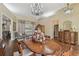 Formal dining room features a chandelier, wood table, and an antique cabinet at 2712 Clubhouse Dr, Plant City, FL 33566