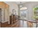 Grand foyer with high ceilings, chandelier, decorative mirror and an elegant console table at 2712 Clubhouse Dr, Plant City, FL 33566