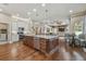 Expansive kitchen features granite counters, stainless appliances, and an oversized island with seating at 2712 Clubhouse Dr, Plant City, FL 33566