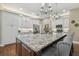 Spacious kitchen island featuring granite countertop, chandelier lighting, and seating at 2712 Clubhouse Dr, Plant City, FL 33566