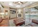 Comfortable living room featuring fireplace, built-in shelving, and access to the screened pool area at 2712 Clubhouse Dr, Plant City, FL 33566