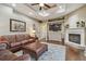 Relaxing living room showcasing coffered ceiling, fireplace, and television at 2712 Clubhouse Dr, Plant City, FL 33566