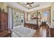Spacious main bedroom featuring a four-poster bed and private access to the pool area at 2712 Clubhouse Dr, Plant City, FL 33566
