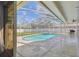 Inviting pool and patio area enclosed with a screen for comfortable outdoor living at 2712 Clubhouse Dr, Plant City, FL 33566