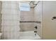 Shower-tub combination with tile surround and bronze fixtures at 2712 Clubhouse Dr, Plant City, FL 33566