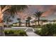 Exterior shot of the community clubhouse with lush landscaping at sunset at 29837 Imperati Blvd, Wesley Chapel, FL 33543